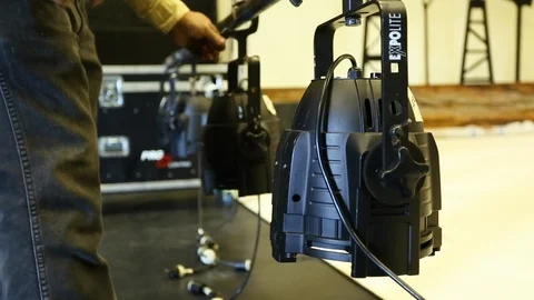 Lighting director rigger about to raise LED light grid above theater set  Stock Footage 125635328