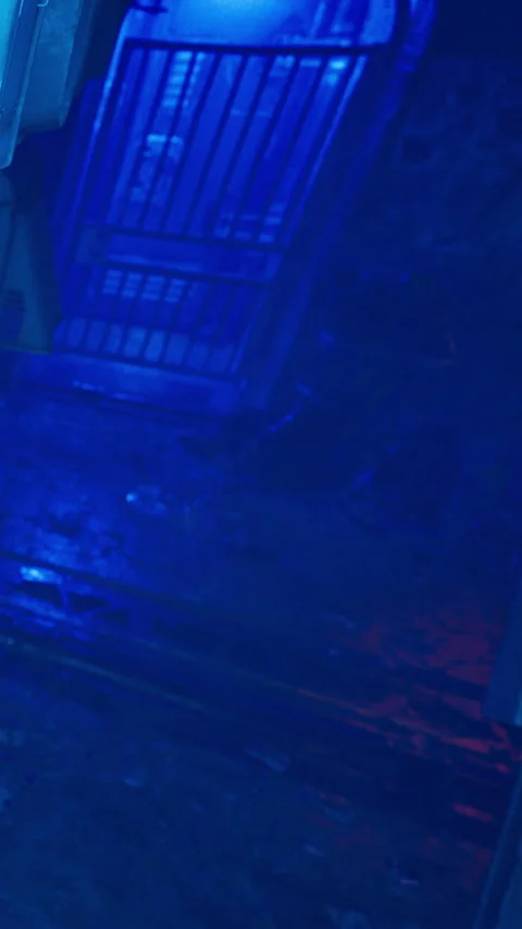 Lighting effects create a blue and red atmosphere in a dark urban space Stock Footage 342337372