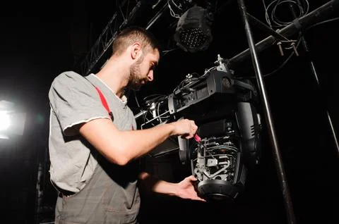 The lighting engineer adjusts the lights on the stage Stock Photos