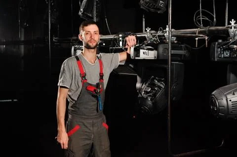 The lighting engineer adjusts the lights on the stage. Stock Photos