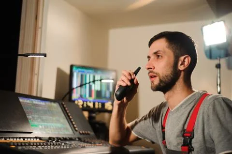 A lighting engineer works with lights technicians control on the concert show Stock Photos