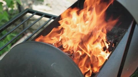 Lighting fire and coals in black metallic grill for smoking and frying meat Stock Footage 137103110