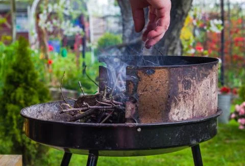 Lighting fire during spring barbecue garden Foto stock