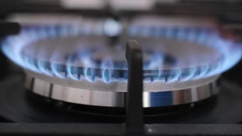 Lighting a fire on a kitchen gas stove. A close-up of the burning flame of the Stock-Footage 253083210
