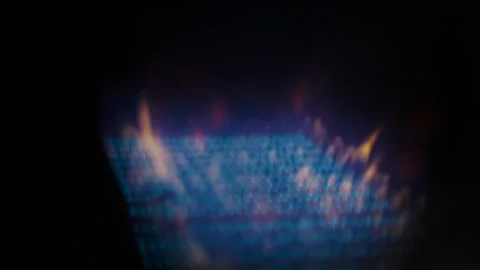Lighting a fire on a kitchen gas stove. A close-up of the burning flame of the Stock Footage 267650475