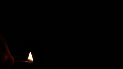 Lighting a fire with a match isolated on black flames yellow and red slow motion Stock Footage 233317025