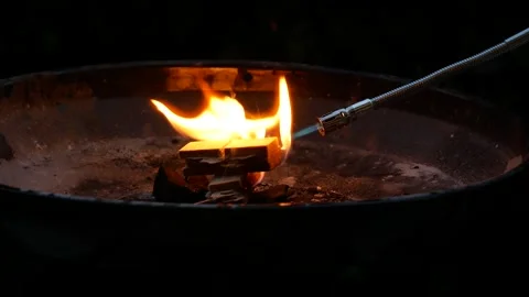 Lighting the fire to start the embers for barbecue Video stock 263981990