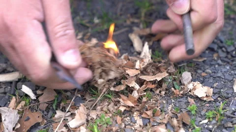 Lighting Fire Using Flint and Steel Stock Footage 303660350