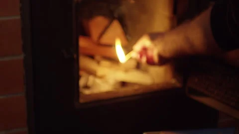Lighting a fireplace with matches and paper Stock Footage 265083044