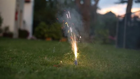 Lighting a firework in a suburbian backyard  Home firework during new year Stock Footage 71200639