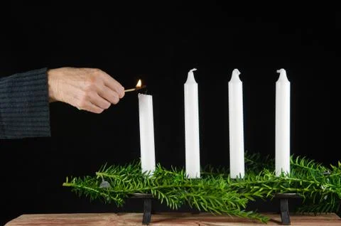 Lighting the first advent candle Stock Photos