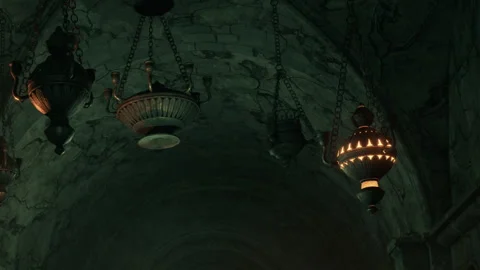 Lighting fixtures hang from the ceiling in a dark stone corridor Stock Footage 344955214