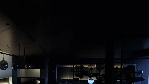 Lighting fixtures hang from the ceiling in a dimly lit indoor space Stock Footage 344849750