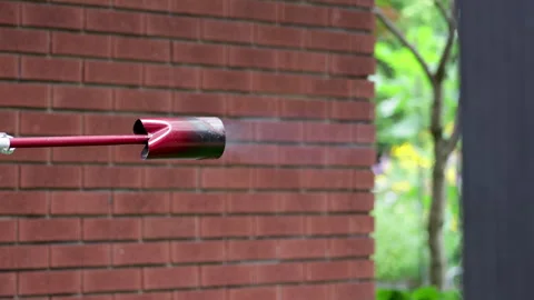 Lighting flame thrower to torch weeds. Stock Footage 342765989