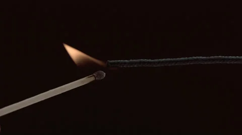 Lighting a fuse with match, slow motion Stock Footage