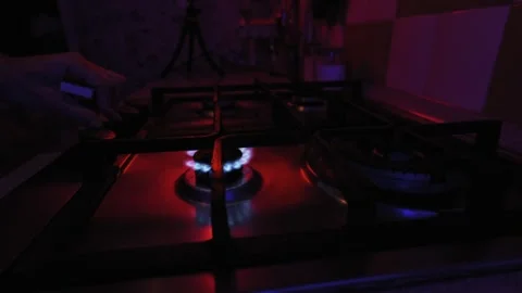 Lighting a Gas Burner with a Match in a Dark Kitchen Stock Footage 325802494