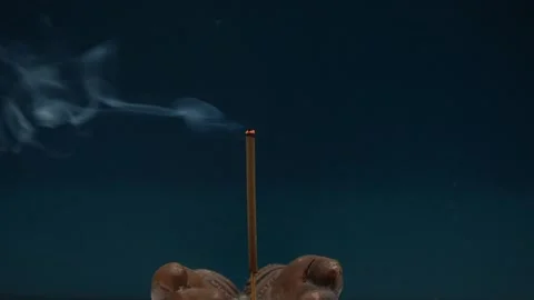 Lighting incense to create a relaxing atmosphere and perfume the room - yoga pra Stock Footage 319020472