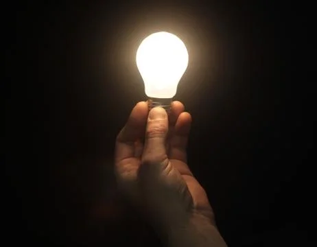 Lighting lamp in hand Stock Photos