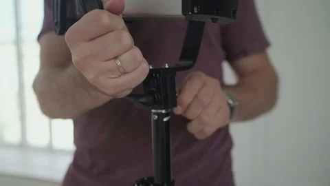 Lighting man placing a sheet of diffuser on a studio light in Video stock 114182370