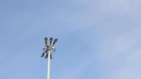 Lighting mast lantern construction on blue sky background 스톡 동영상 129312870