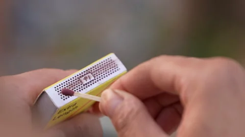 Lighting a match against a matchbox 库存影片 293110183