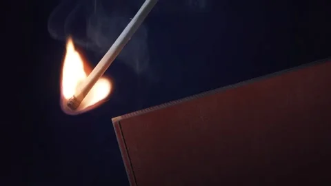 Lighting a match in the dark, close up Stock Footage 136072789