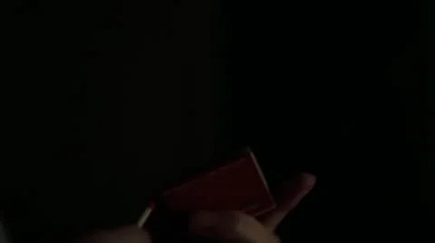 Lighting a match in the dark Stock Footage 12491536
