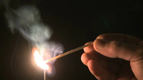 Lighting up a match in the dark. Stock Footage 62556387