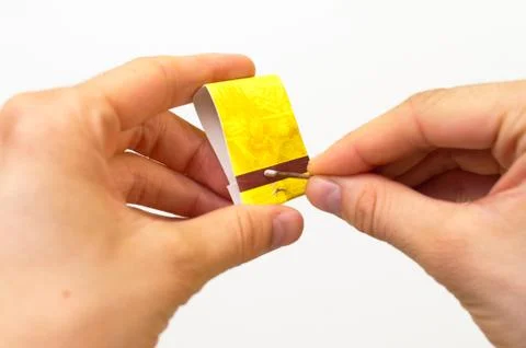 Lighting a match from a matchbook Stock-Fotos