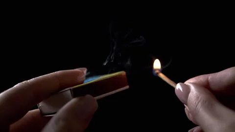 Lighting Match on Matchbox in Dark Room, Close up Stock Footage 312013633