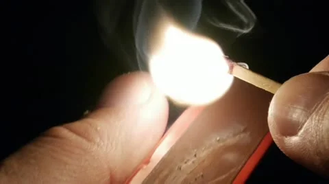 Lighting a Match Slow Motion. Detail Shot. Black Background. Stock Footage