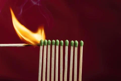 Lighting matches in a row. Stock Photos