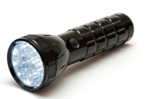 Lighting metallic flashlight Stock Photos