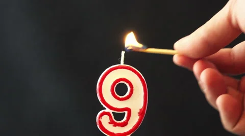 Lighting a number nine candle Stock Footage 47859360