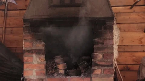 Lighting an old brick oven in a forge, close-up Stock Footage 317088337