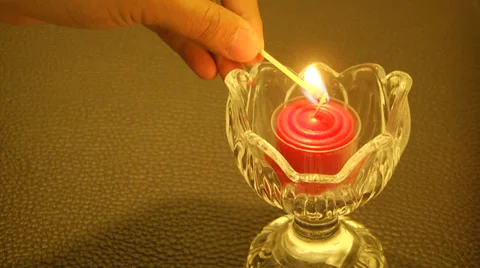 Lighting up Red Candle Stock Footage 36860162