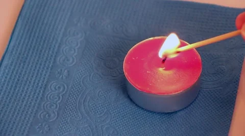 Lighting a red candle Stock Footage 49205576