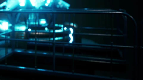 Lighting setup next to metal railing in a dark room with blue lights Stock Footage 344967411