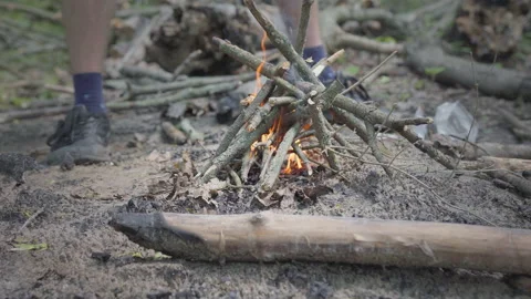 Lighting up a small fire in the forest. Low angle view of the fire with flames Stock Footage 161892039