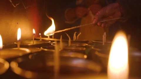 Lighting small lamps with a stick Stock Footage 77446814