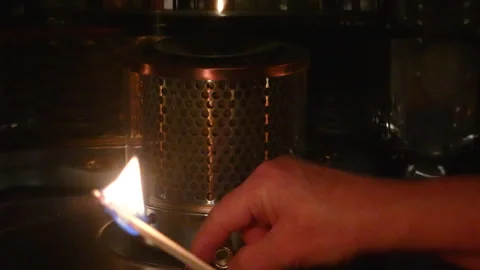 Lighting a space heater with a Match Stock Footage 299945883