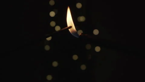 Lighting up a sparkler on black background with bokeh Stock Footage 146701520