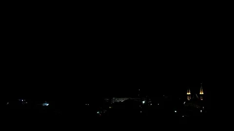Lighting storm over see and beach town with church Stock Footage 81144458