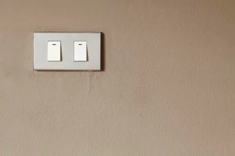 Lighting switch on wall Stock Photos