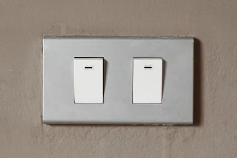 Lighting switch on wall Stock Photos