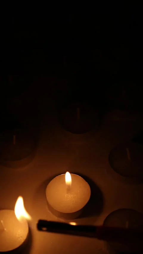Lighting Tea Candles One by One in Dark Warm Romantic Scene 스톡 동영상 340414403