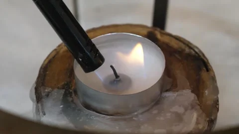 Lighting a Tea Light Candle in a Decorative Coconut Shell Holder Stock Footage 337678917