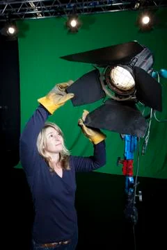 Lighting technician in television studio Stock Photos