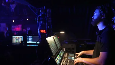 Lighting technician works on the lighting console at a live show concert event Video stock 201950694