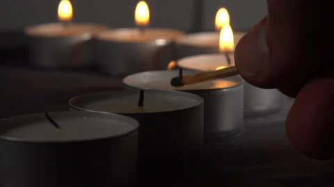 Lighting up three tealights from a row 스톡 동영상 136296225